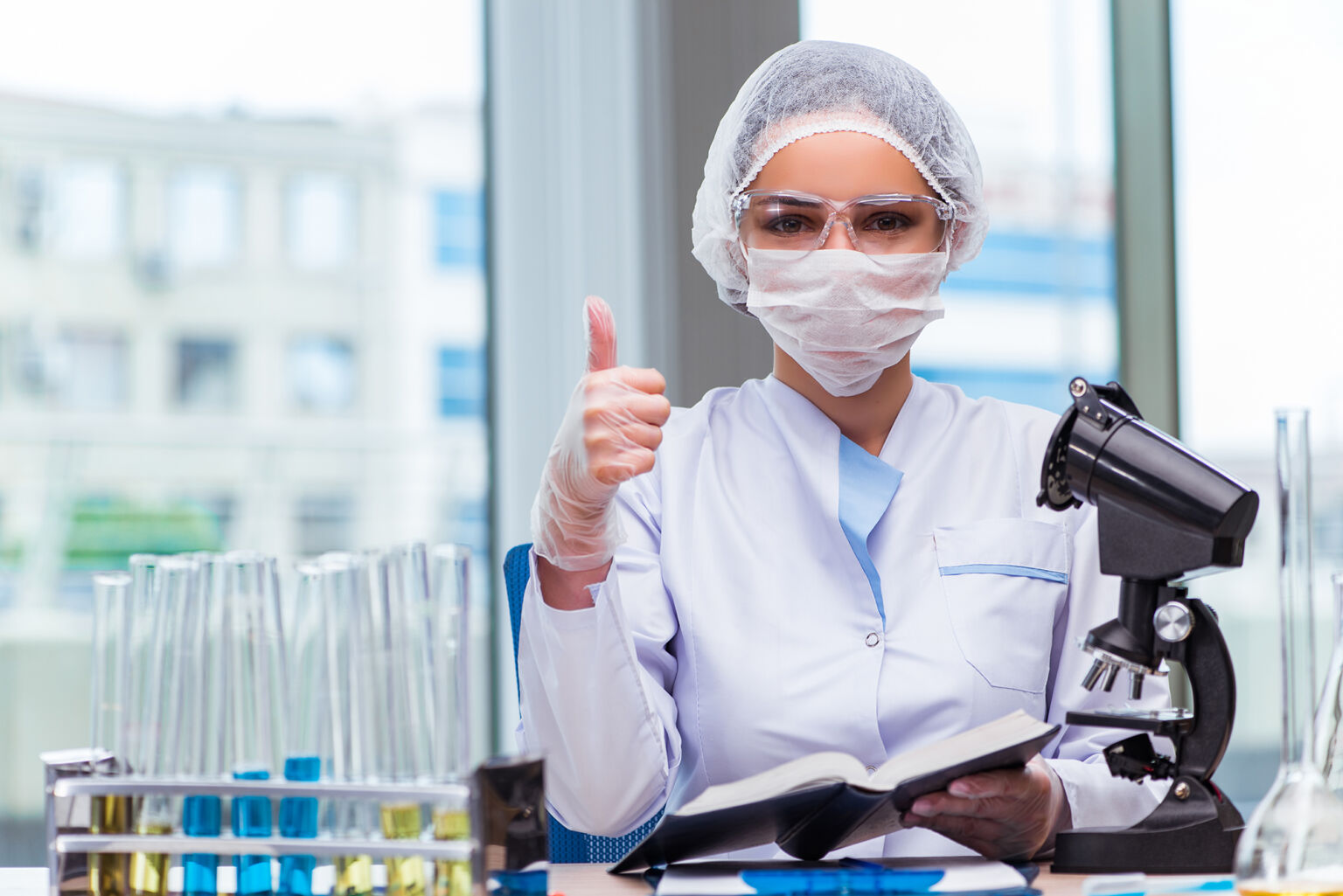 Young student working with chemical solutions in lab